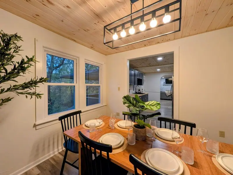 Warm pendant light over a table set for six. Dinner might just be the best part of the day.