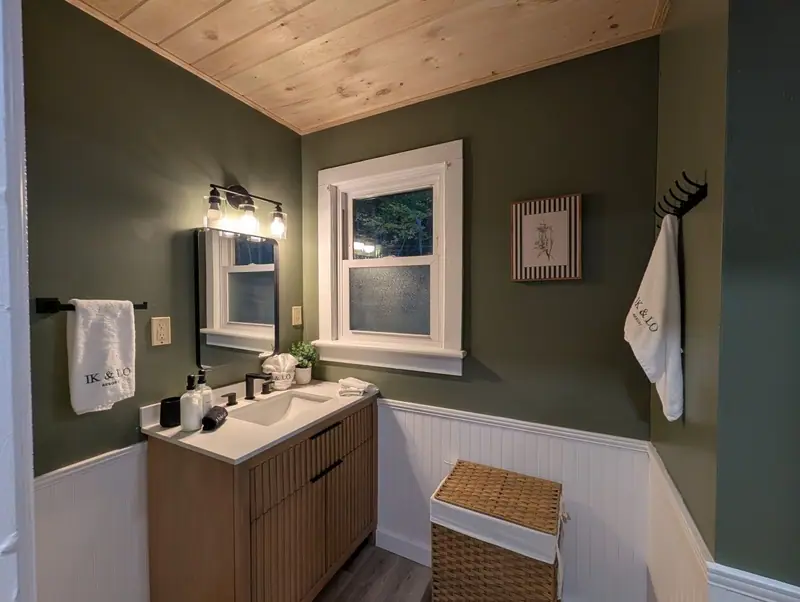 Wood vanity, a sunny window and fresh towels. A bathroom that keeps mornings simple.