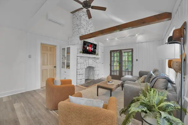 Living Room: Bright and airy space with a charming fireplace and plush seating for relaxation!
