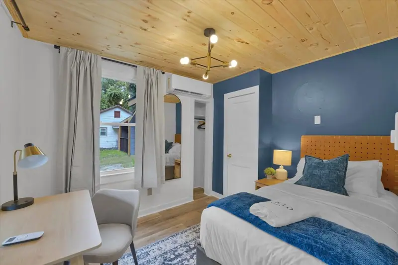 A cozy private bedroom with a dedicated workspace for checking in—or completely switching off.