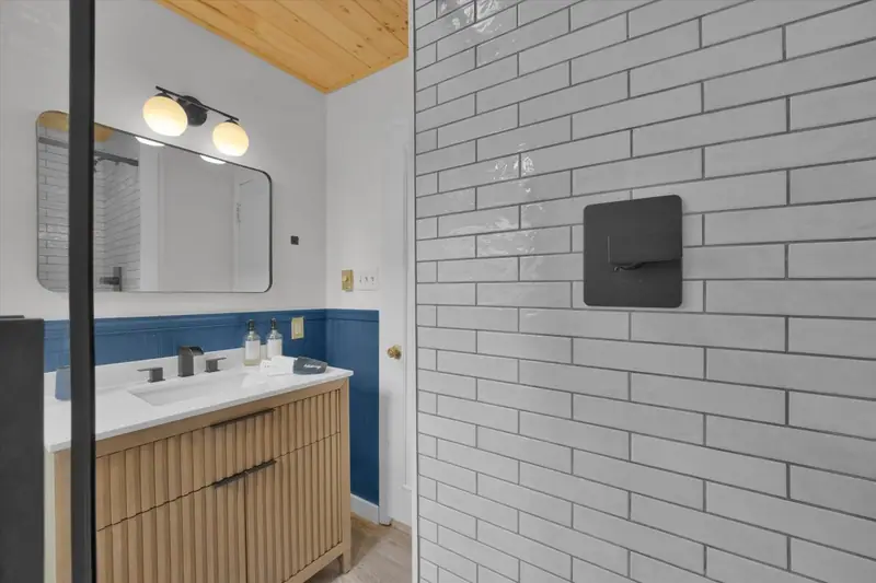 Refresh in a modern walk-in shower with classic subway tile and sleek black fixtures.