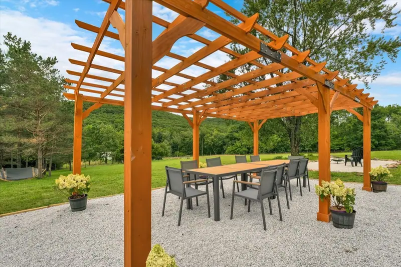 Summer breezes and rolling green hills beyond the timber beams. A view worth pausing for.