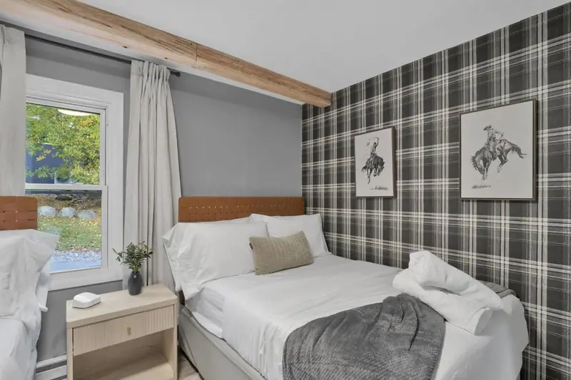 Bedroom 3 with a plaid accent wall