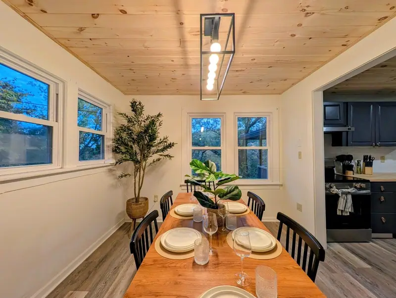 Kitchen to table in a few steps, with treetop views through every window.